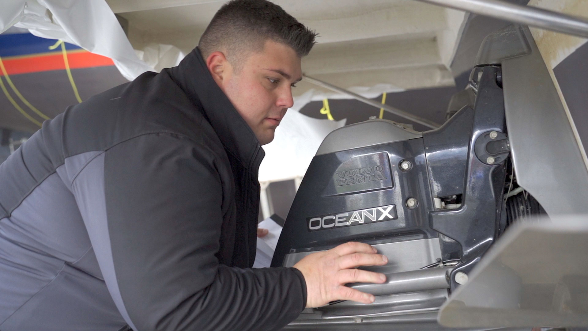 Marine Technician working on a motor at Bay Port YC