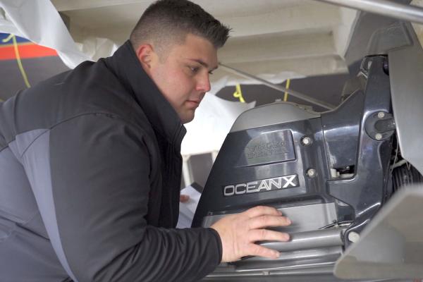 Marine Technician working on a motor at Bay Port YC