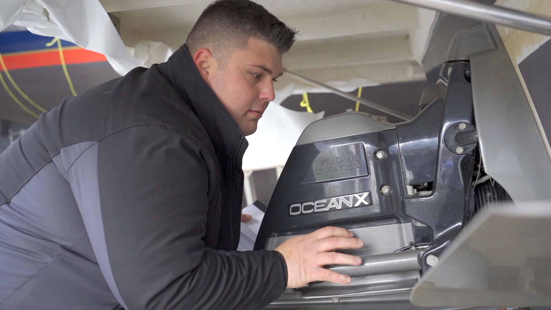 Marine Technician working on a motor at Bay Port YC